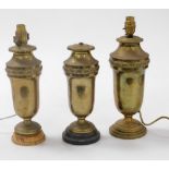 Three early 20thC brass vases, embossed with bands of fir cones and scrolls, converted to table lamp