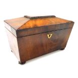 A Regency mahogany sarcophagus form tea caddy, the hinged lid opening to reveal two lidded compartme