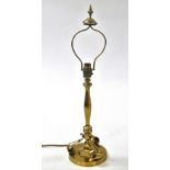 A late Victorian brass lamp, converted for electricity, of hexagonal form, raised on three scroll fe