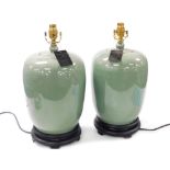 A pair of Chinese celadon vase and cover table lamps, raised on socle bases, 44cm high.