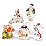 A group of 19thC Staffordshire pottery, including a seated figure with a jug of ale, tree formed spi