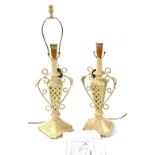 A pair of early 20thC Minister Gift ware cream painted wooden and cast iron table lamps, with leaf s