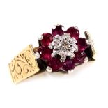 A 9ct gold ruby and diamond flower head ring, high claw set, size L, 3.6g.