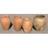 A pair of terracotta plant pots, each of fluted cylindrical tapering form, 34cm high, together with