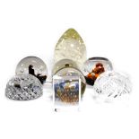 A group of cut glass paperweights, including Caithness Diadem, Moon Flower, and Cosmos paperweights.