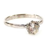 A diamond solitaire ring, the round brilliant cut 0.75 carat diamond set in an eight claw mount, col