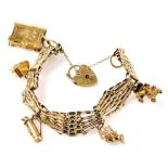 A 9ct gold gate charm bracelet, with five charms as fitted, on a heart shaped padlock clasp, with sa