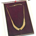 A 9ct gold four stand fringe necklace, on a lobster claw clasp, boxed, 11.4g.