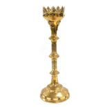 A Victorian brass Gothic Revival pricket altar candlestick, embossed with flower heads and engraved