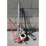 A pipe or tube bender, together with various other tools, golf clubs, etc.