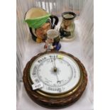 An oak cased aneroid barometer, 25cm diameter, together with a Royal Doulton Sairey Gamp character j