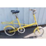 A Moulton Bicycles junior bicycle, in yellow trim.