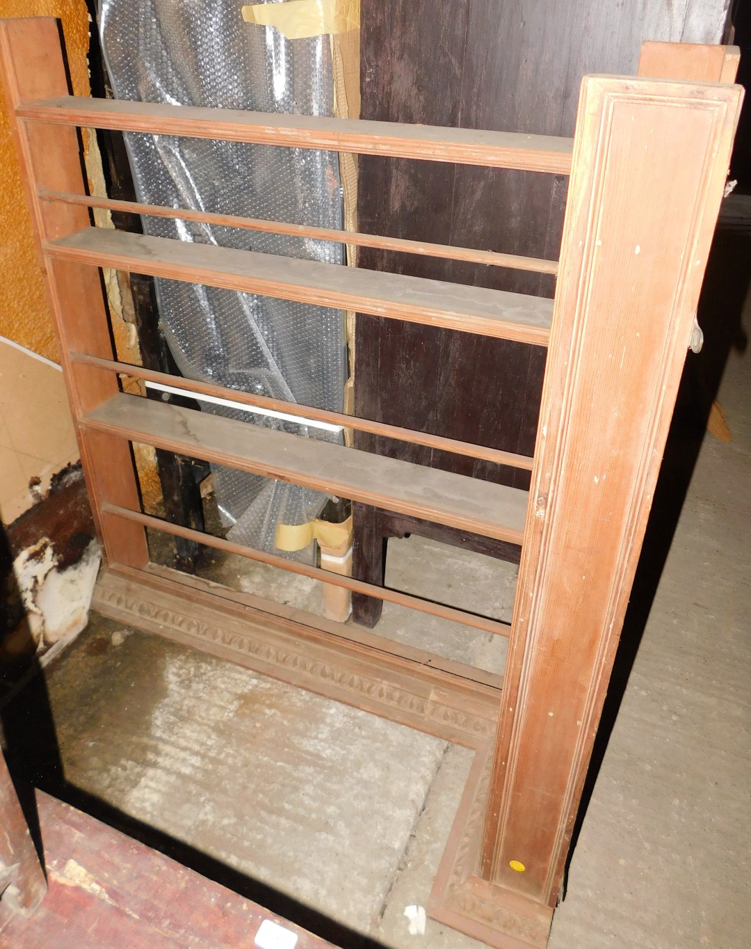 An oak corner plate rack, with moulded edges and a carved cornice, 127cm wide.