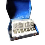 A Hohner Verdi III piano accordion, in a fitted case.