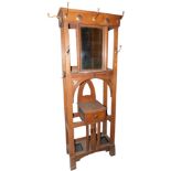 An early 20thC oak hall stand in the manner of Liberty, with hammered copper panels, the top with a
