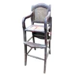 A late 19th/early 20thC high chair, with a caned back, a rattan woven seat, on splayed legs with tur