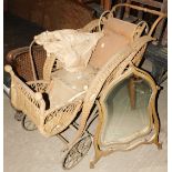 A Victorian basket work or rattan child's pram or pushchair, with solid spoked wheels and turned woo