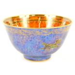 An early 20thC Wedgwood bird lustre bowl, decorated internally with a bird against a mottled orange