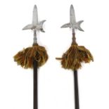 Two mid 19thC steel ceremonial Halberds, with wooden shafts, 237cm and 236cm high.
