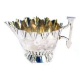 A small silver plated cream jug, with fluted castellated top and stylised handle, Regd No 79127, 5.5