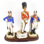 Three porcelain military figures, comprising an 1840 Officer Grenadier Guards, an East German porcel