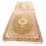 A pair of Middle Eastern carpets, each decorated with central medallion in gold and red colouring, w