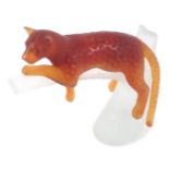 A Daum model of a leopard perched on branch, in orange and clear glass design, stamped Daum France,
