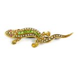 A Victorian lizard brooch, set with seed pearl, peridot, and garnet, yellow metal stamped 15c, on si