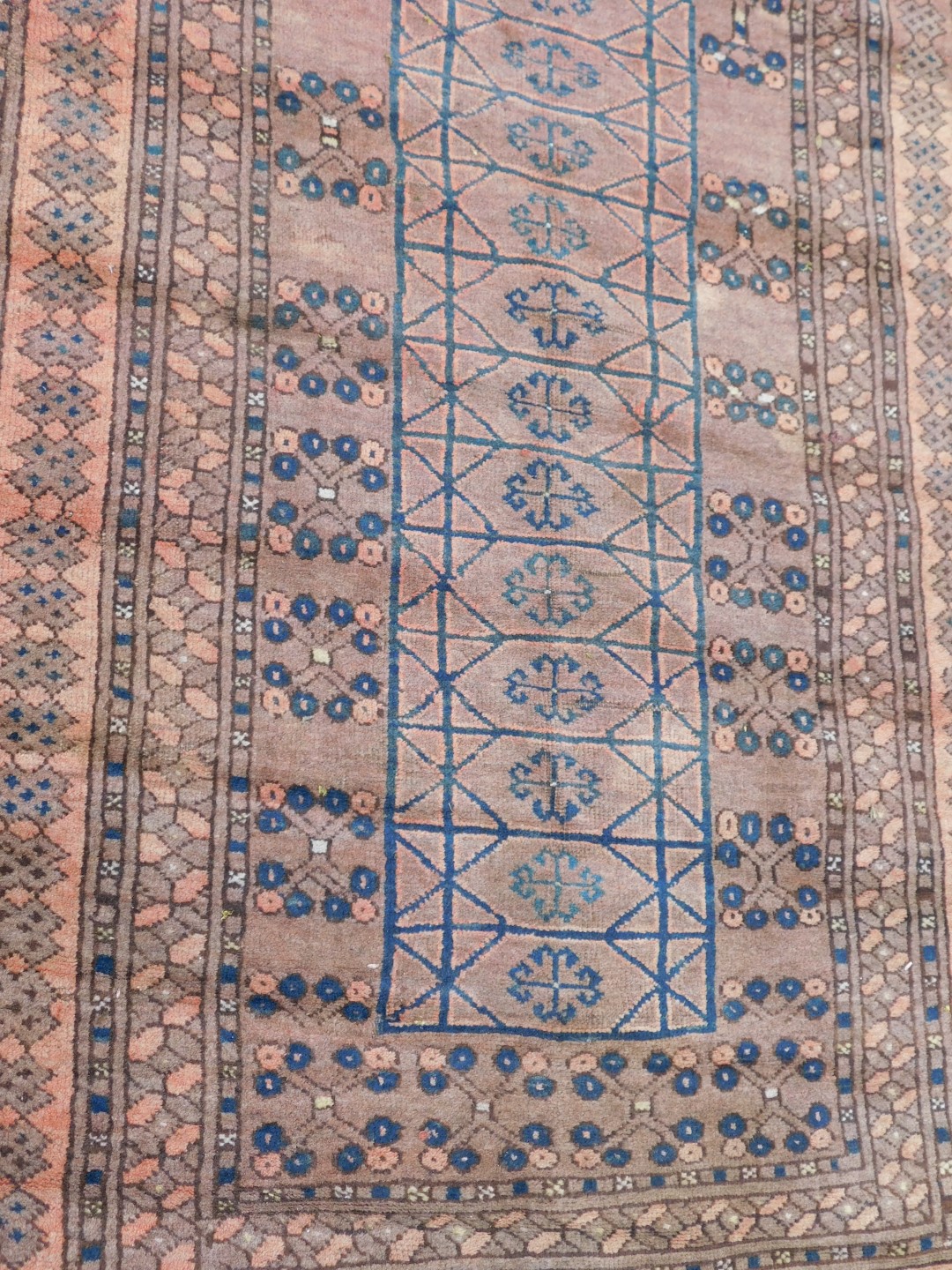 An Afghan red ground rug, the central ground decorated with floral motifs within rectangular compart - Image 2 of 3