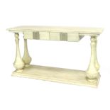 An early 20thC French cream painted console table, with two frieze drawers, raised on fluted and bal