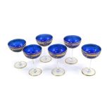 A set of six Murano glasses, on a blue ground with gilt border and white painted dot decoration, 15c