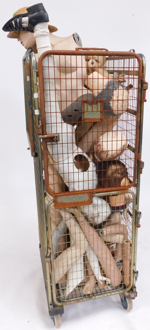 A quantity of mannequin parts, comprising two torsos, heads, legs, arms, feet, etc. (1 cage)