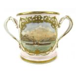 A late 19thC ceramic loving cup, with a gilt border and handles around a central painted panel of st