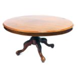 A Victorian mahogany oval tilt top breakfast table, raised on a turned column over four carved cabri