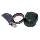 World War II German officer's blue peak cap, a green peak cap with applied badge with bullseye, and