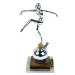 An Art Deco chrome figural table lighter, in the form of a nude female dancer, raised on a spherical