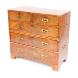 A Victorian teak and brass military chest, of two short and three long drawers, raised on bracket fe