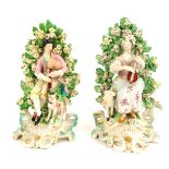 A pair of 19thC Continental porcelain figure groups in Derby style, depicting male and female playin