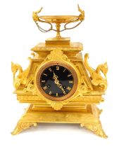 A 19thC French ormolu mantel clock, urn finial, with swan and lion mask swag handles, and a black en