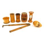 A group of treen, comprising a Leamington Spa egg cup, a treen dice shaker, egg timer, Forth Bridge