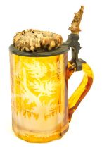 A late 19thC amber flash Bohemian tankard, with etched glass design, of stag and trees, with antler