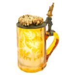 A late 19thC amber flash Bohemian tankard, with etched glass design, of stag and trees, with antler