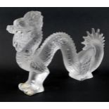 A Lalique model of a dragon, clear glass, signed Lalique France, 28cm wide, boxed.