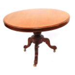 A Victorian mahogany tilt top breakfast table, the circular top raised on a turned column, over leaf