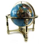 A gemstone globe by Lapis Globes, on a brass effect swivel base, 40cm high, the base 30cm x 30cm.