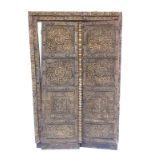 A pair of late 19th/early 20thC Eastern doors, each carved with roundels, leaves, etc., and with gil