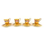 A set of four KPM porcelain coffee cans and saucers, each heavily gilt decorated with a floral bande