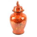A Carltonware orange lustre jar and cover, of large proportions with dog of fo handle and hand paint