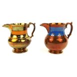 Two copper lustre ware jugs, one with blue border, with other with orange, 14cm high. (2)