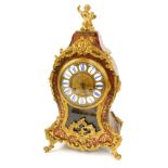 A late 19thC Boulle mantel clock, tortoiseshell and brass inlaid case, with applied figure of a chil